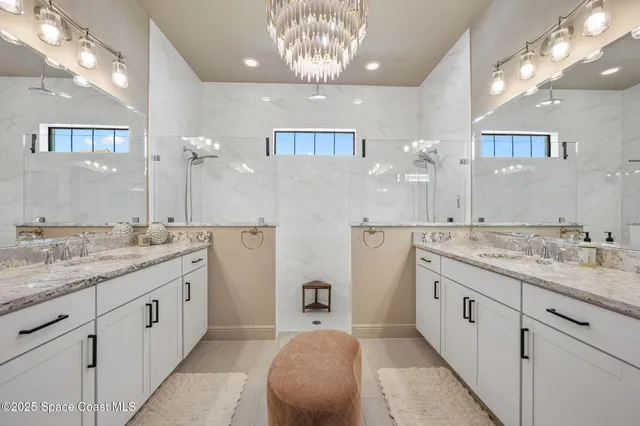 a view of a patio with table and chairs potted plants and floor to ceiling window