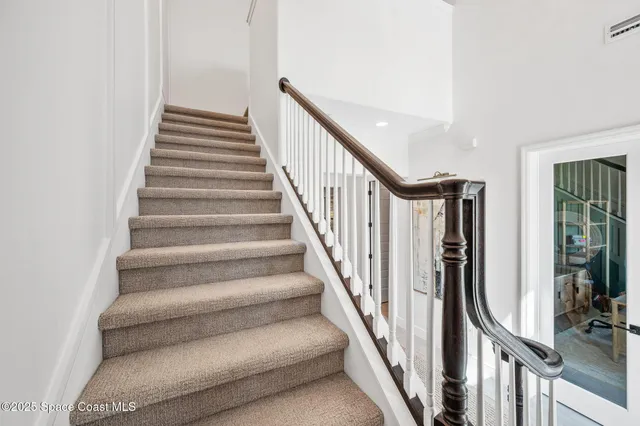 an aerial view of a pool yard tennis courts and ocean view