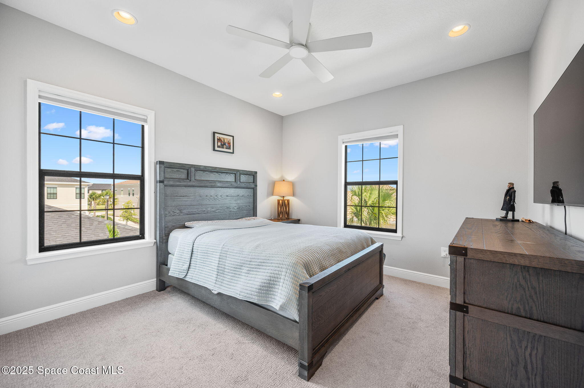2444 Addison Drive Melbourne, FL 32940 - Photo 39 of 93 a bedroom with a bed and a dresser next to a window