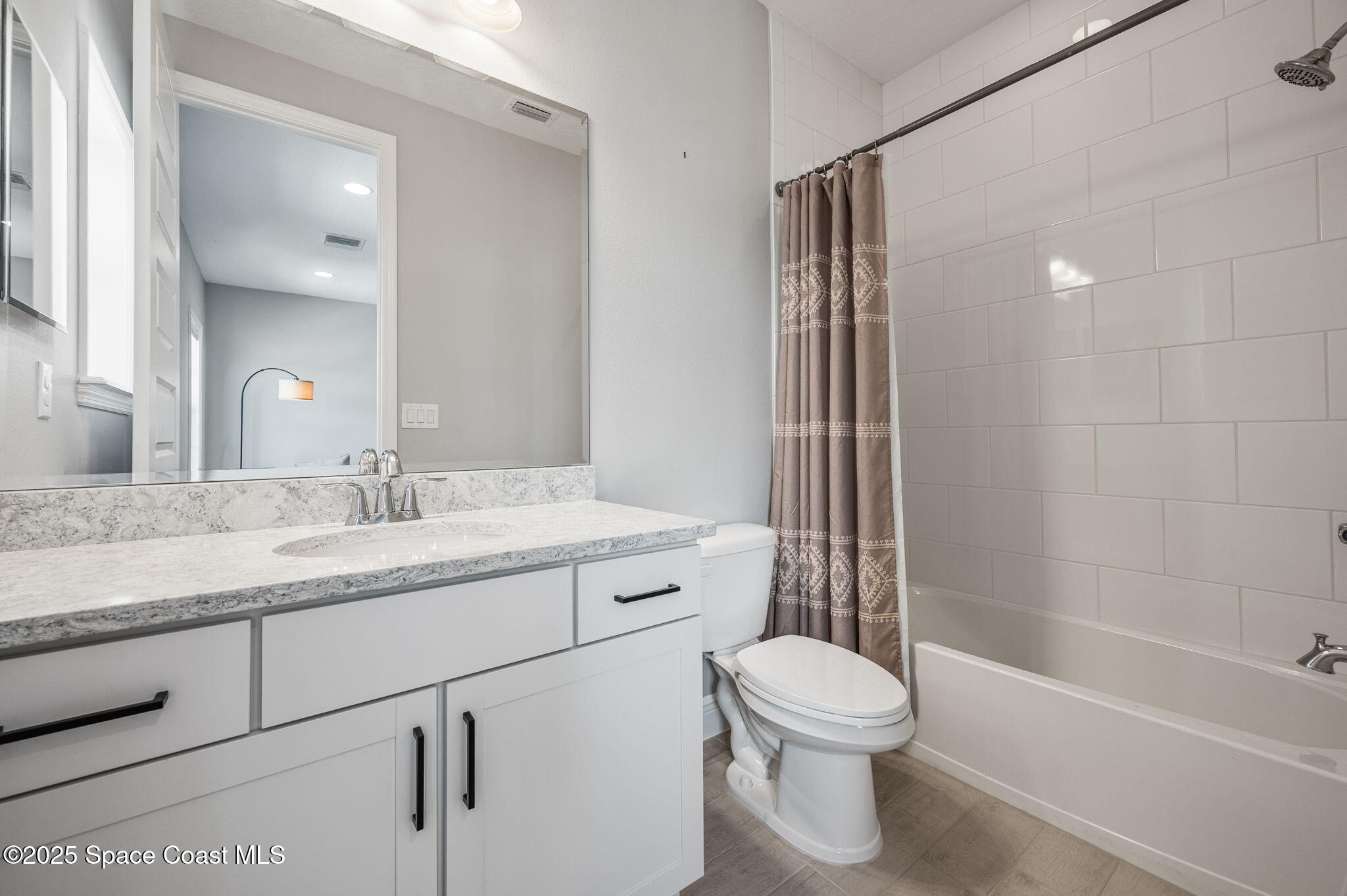 2444 Addison Drive Melbourne, FL 32940 - Photo 47 of 93 a bathroom with a granite countertop sink a toilet and shower