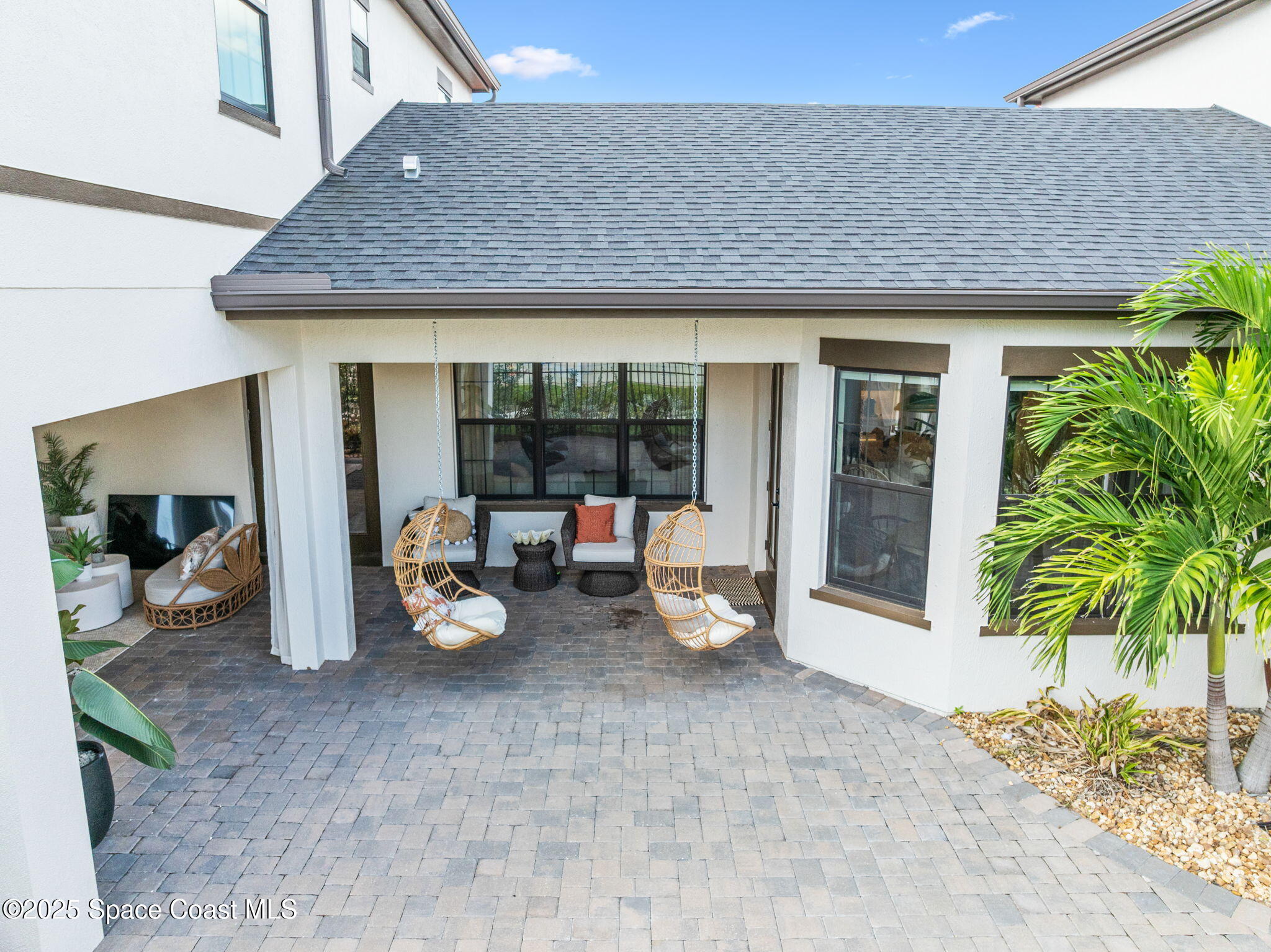 2444 Addison Drive Melbourne, FL 32940 - Photo 55 of 93 a view of a patio with table and chairs potted plants and floor to ceiling window