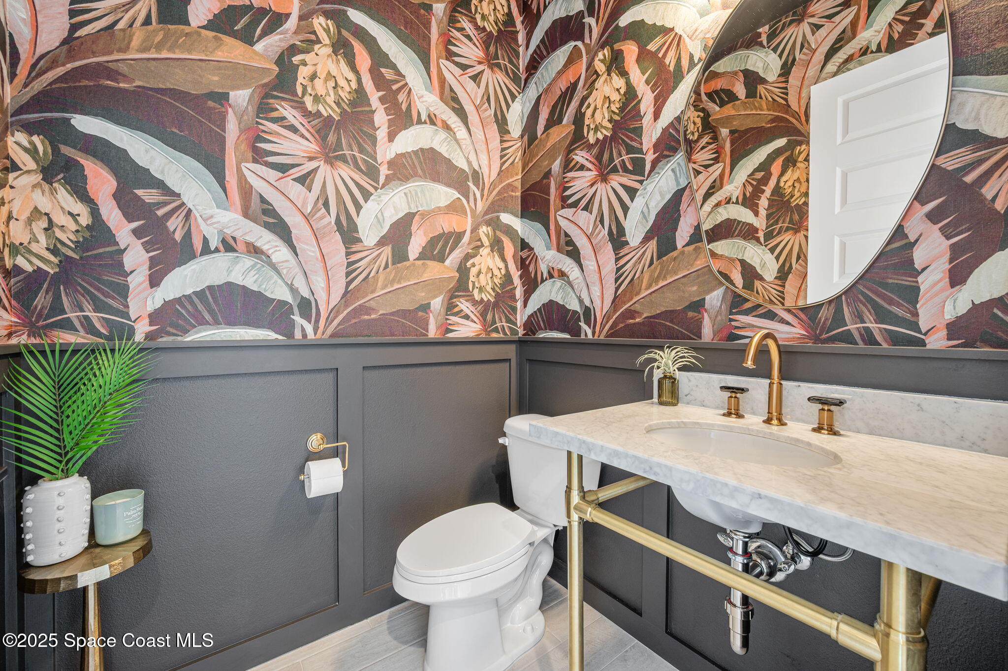 2444 Addison Drive Melbourne, FL 32940 - Photo 6 of 93 a bathroom with a sink a toilet and a mirror