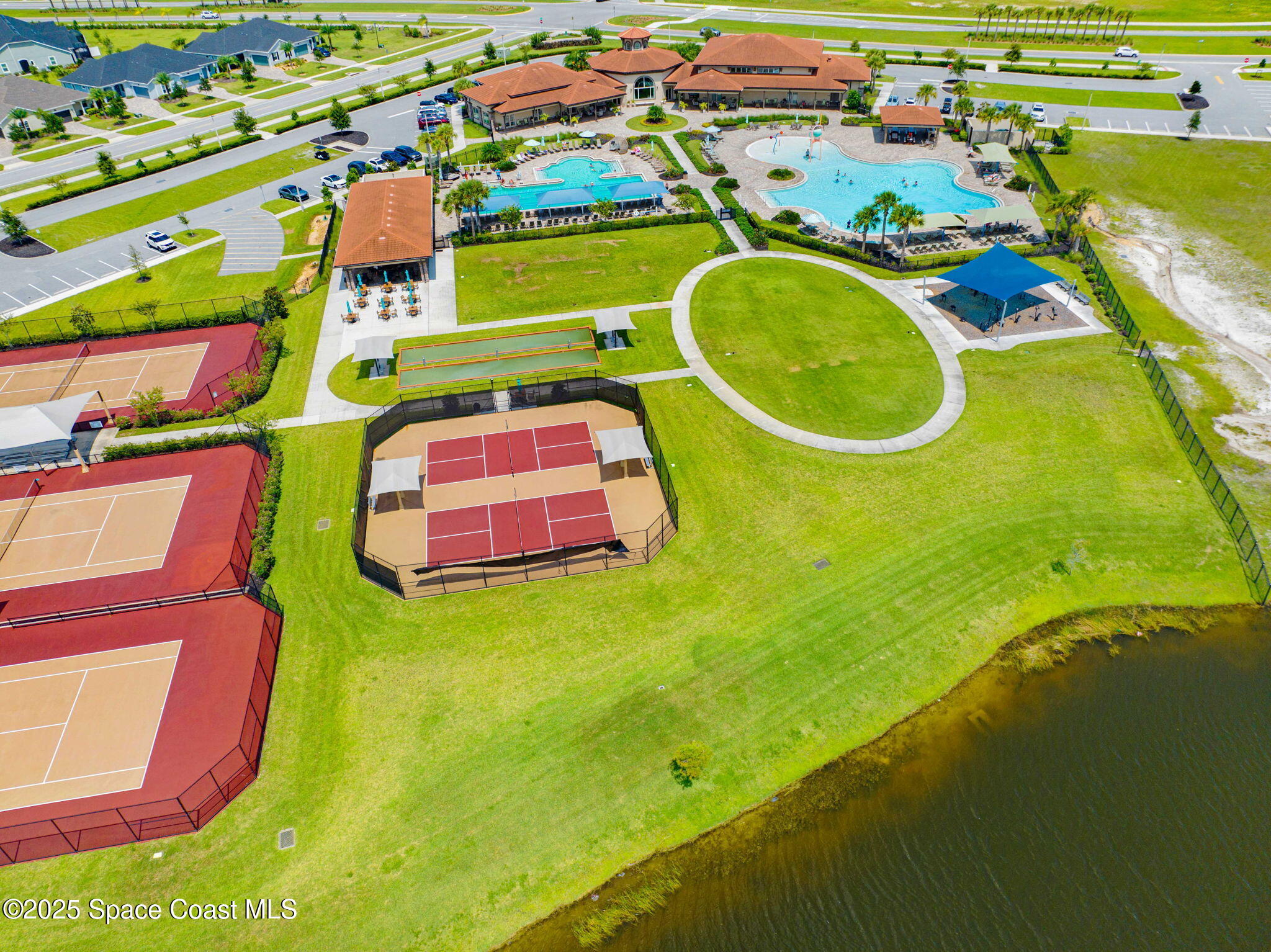 2444 Addison Drive Melbourne, FL 32940 - Photo 68 of 93 an aerial view of a pool playground residential houses with outdoor space and swimming pool