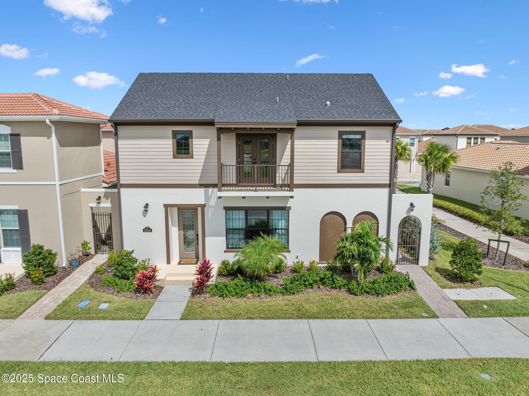 2444 Addison Drive Melbourne, FL 32940 - Photo 77 of 93 a front view of a house with a yard and potted plants