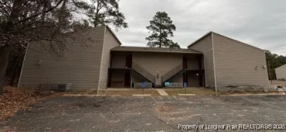 a view of a house with a tree
