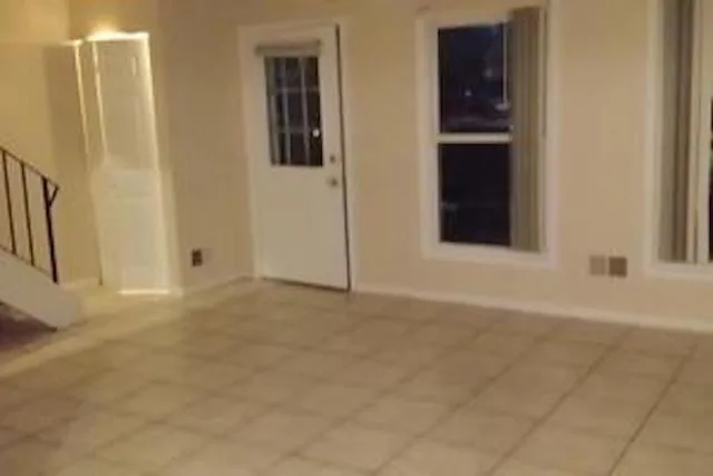 a view of an empty room with windows