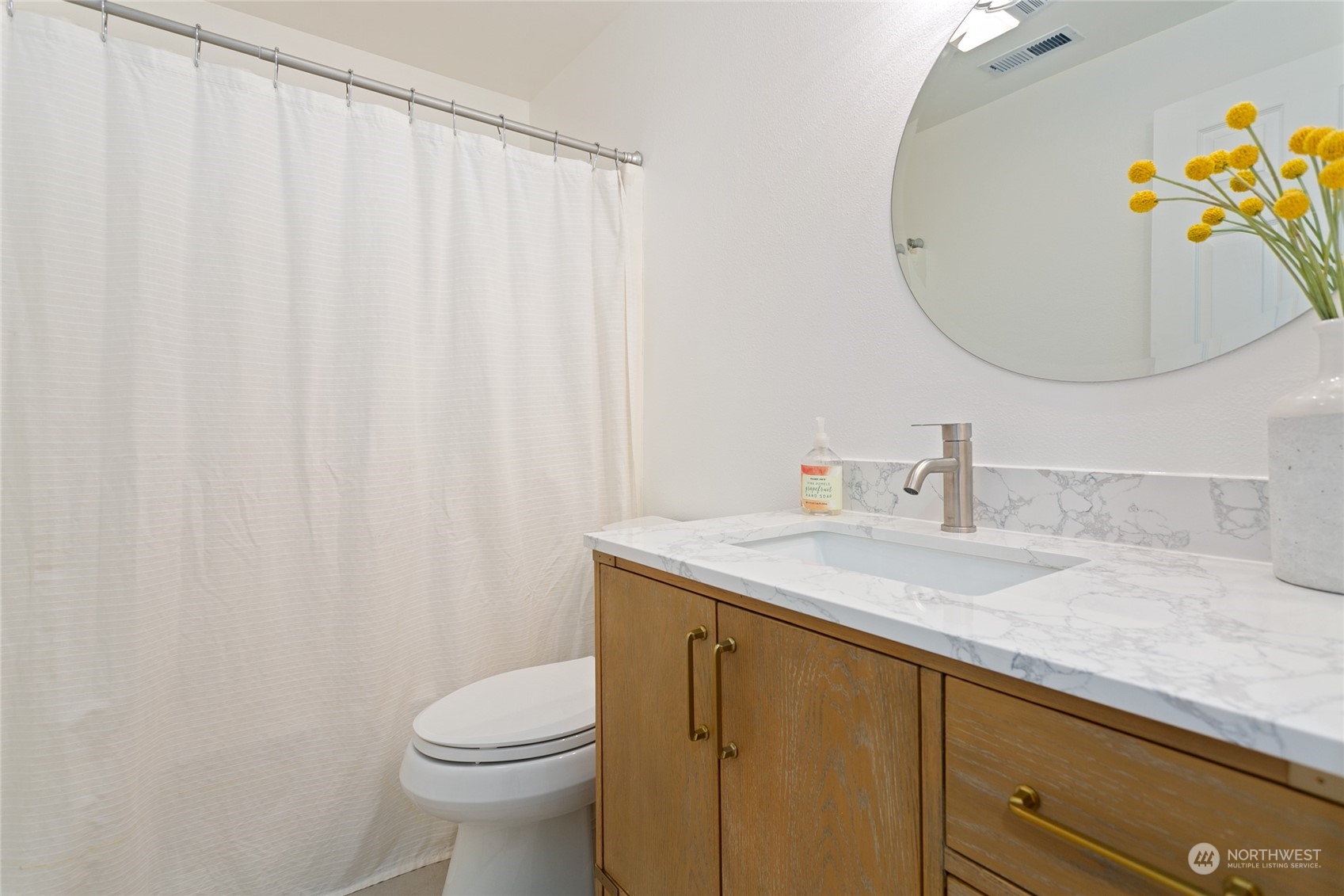 3835 Spring Coulee Road Bellingham, WA 98226 - Photo 17 of 30 a bathroom with a granite countertop sink and a mirror