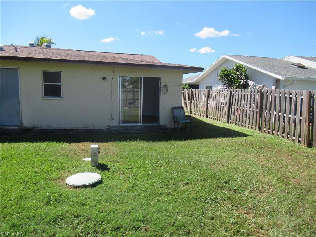 7461 Pebble Beach Road Fort Myers, FL 33967 - Photo 11 of 11 a backyard of a house with table and chairs