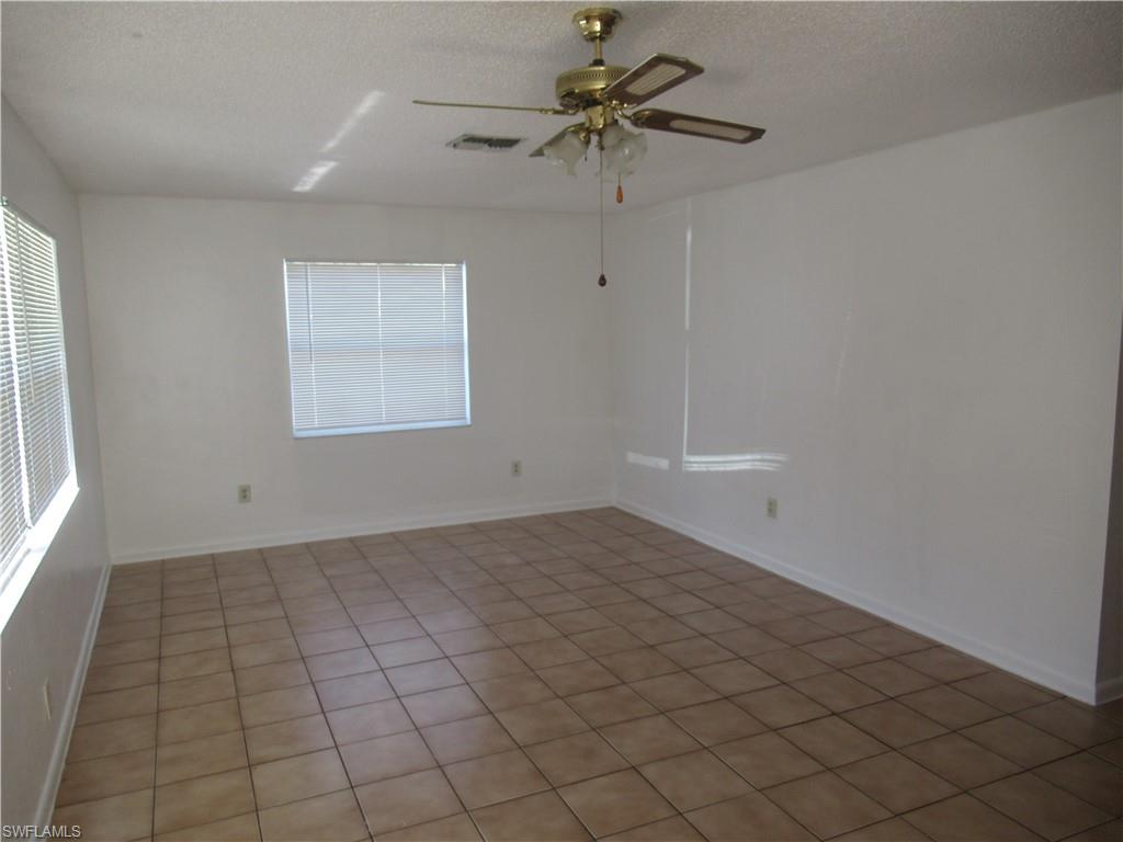 7461 Pebble Beach Road Fort Myers, FL 33967 - Photo 2 of 11 an empty room with a ceiling fan and window