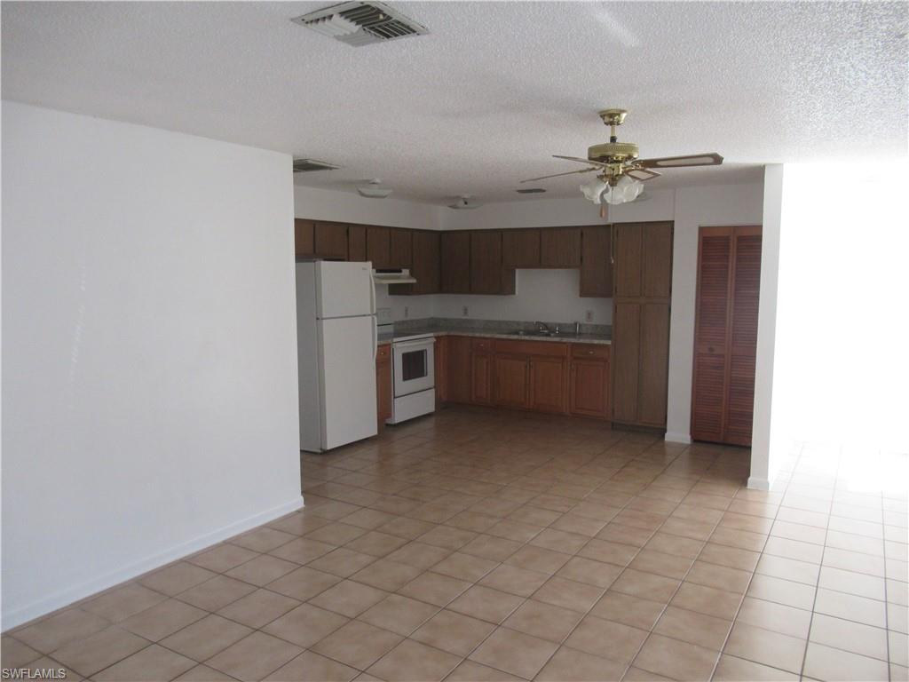 7461 Pebble Beach Road Fort Myers, FL 33967 - Photo 3 of 11 a view of a kitchen with a sink and dishwasher