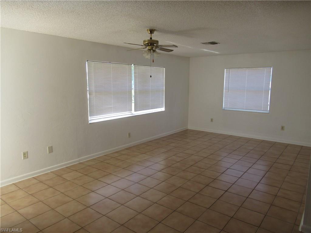 7461 Pebble Beach Road Fort Myers, FL 33967 - Photo 5 of 11 an empty room with a chandelier fan