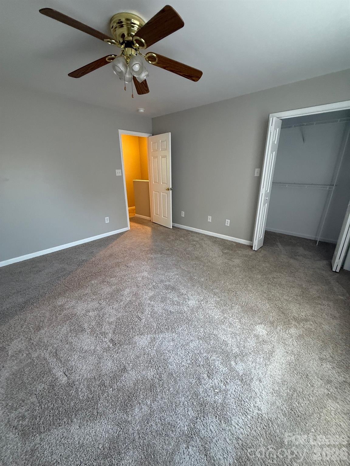 1009 22nd Street Northeast Hickory, NC 28601 - Photo 6 of 8 an empty room with windows and fan