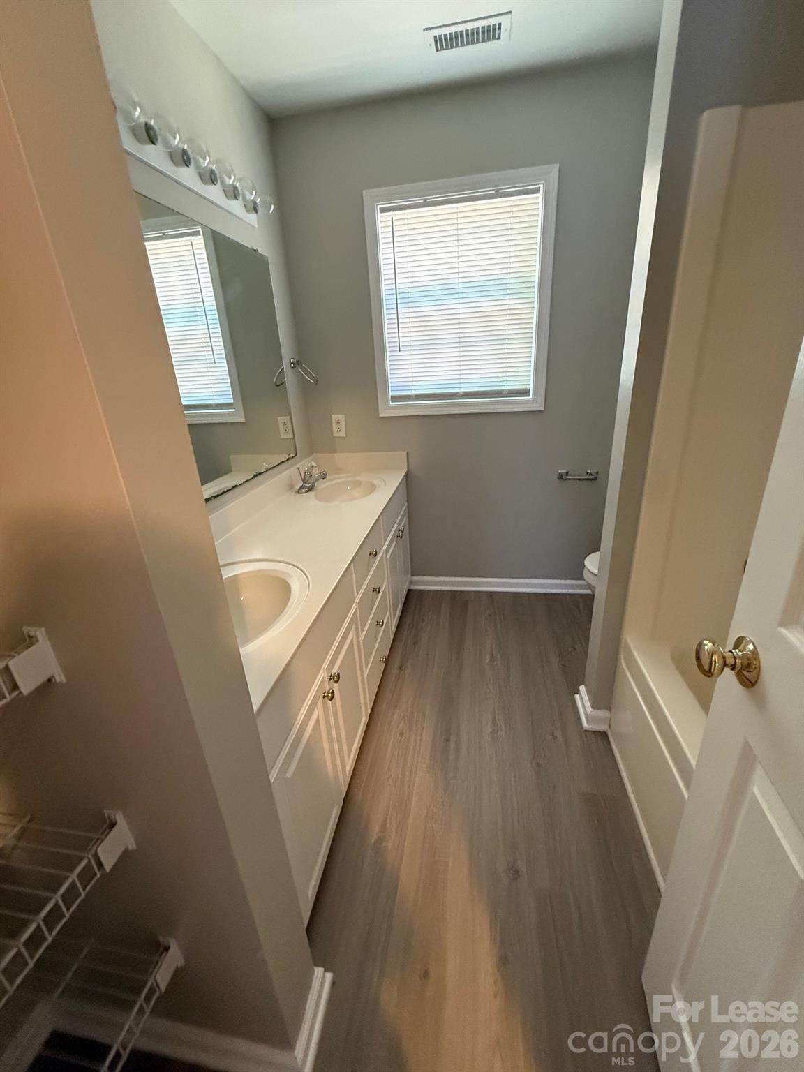 1009 22nd Street Northeast Hickory, NC 28601 - Photo 7 of 8 a bathroom with a sink a mirror and a bathtub