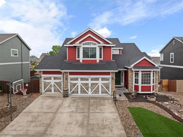 a view of a livingroom with wooden floor and furniture