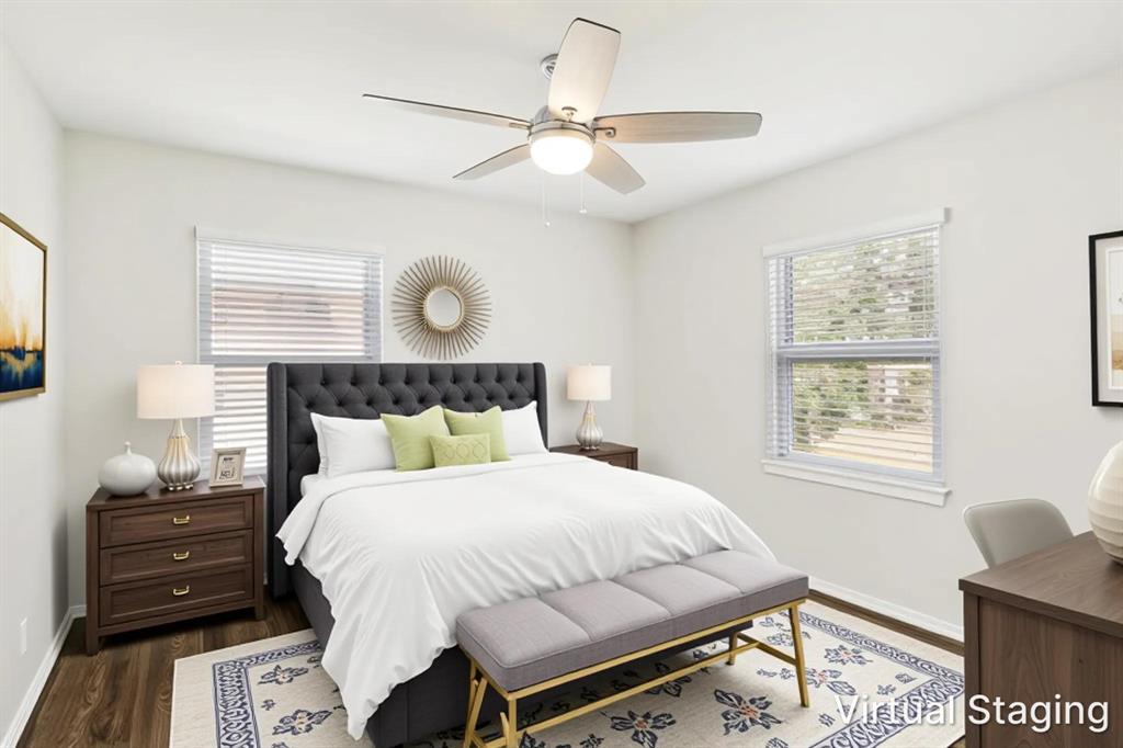11524 Strand Street Dallas, TX 75218 - Photo 14 of 19 a bedroom with a bed and dresser with wooden floor