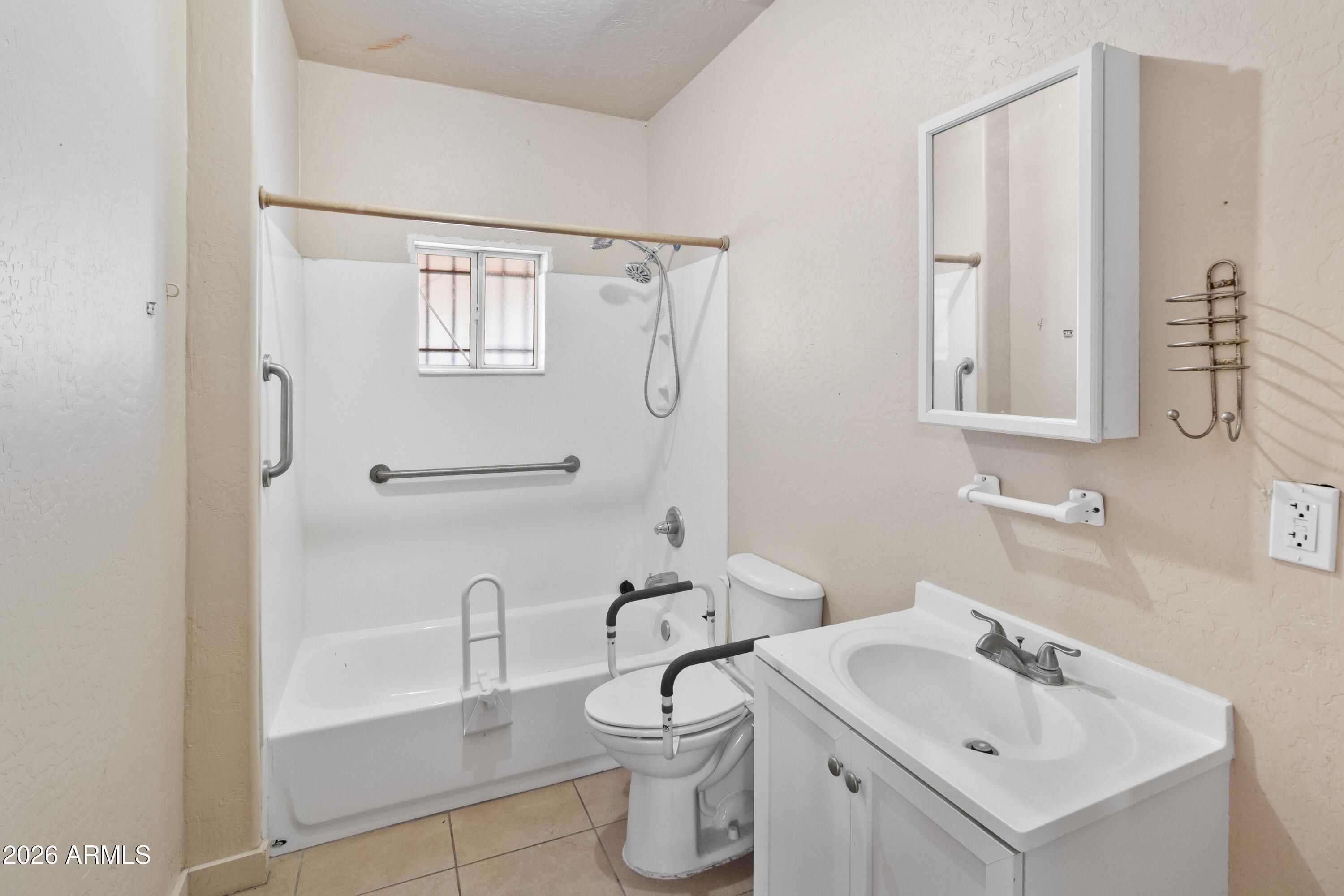 1237 East Pierce Street Phoenix, AZ 85006 - Photo 16 of 23 a bathroom with a toilet sink and mirror