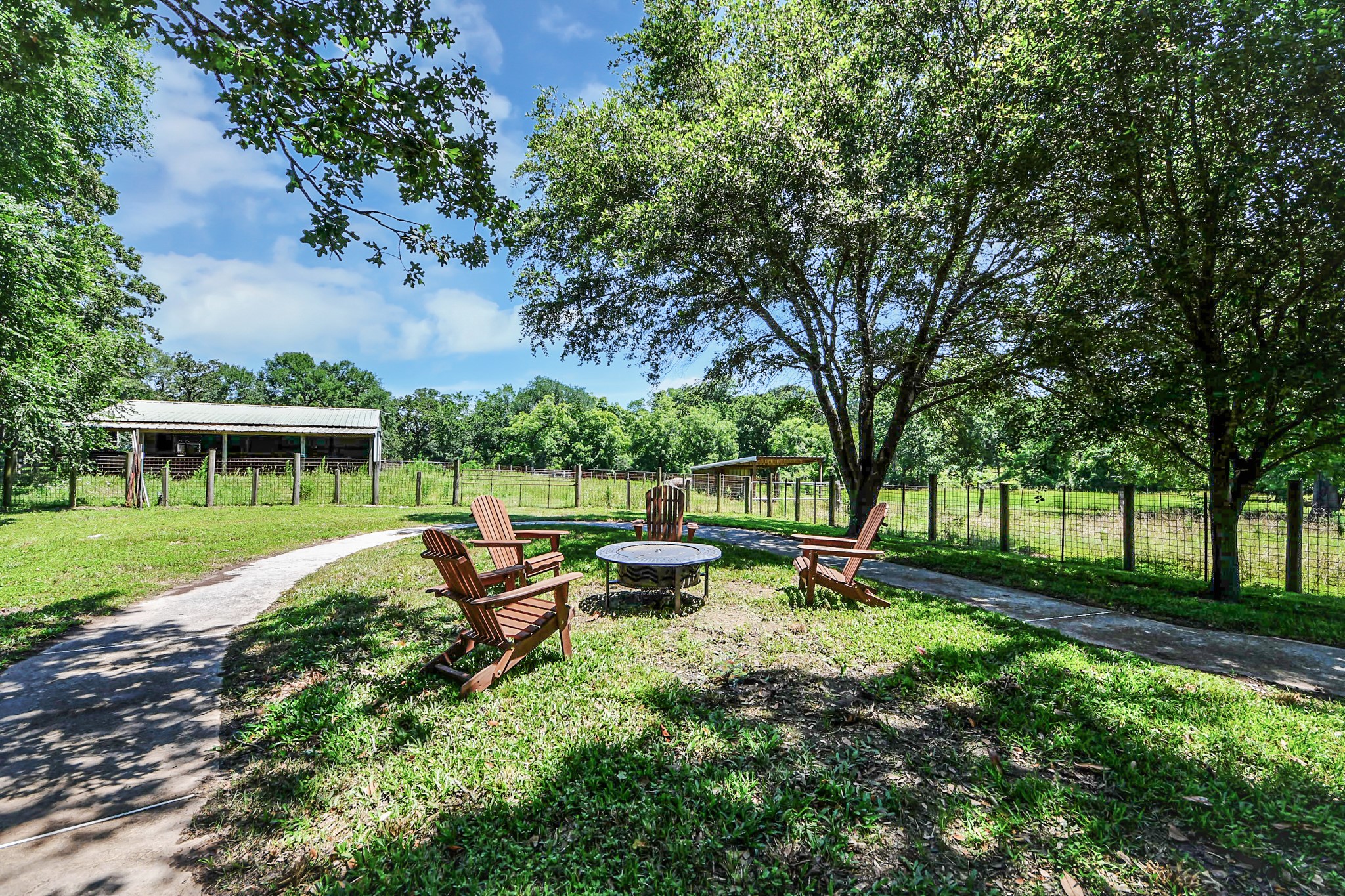 28222 Margerstadt Road Waller, TX 77484 - Photo 37 of 50 Gather around the fire pit and enjoy quiet evenings beneath the shade of towering trees.