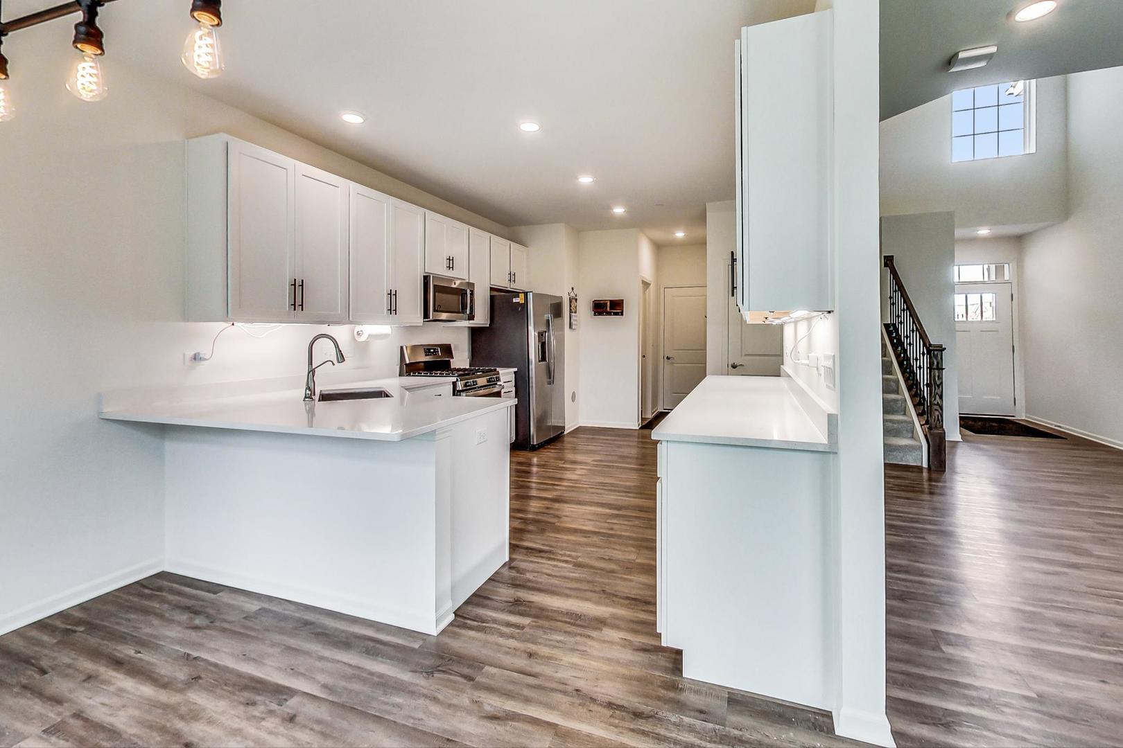 1663 Kraft Avenue Batavia, IL 60510 - Photo 11 of 47 a kitchen with stainless steel appliances refrigerator microwave and stove