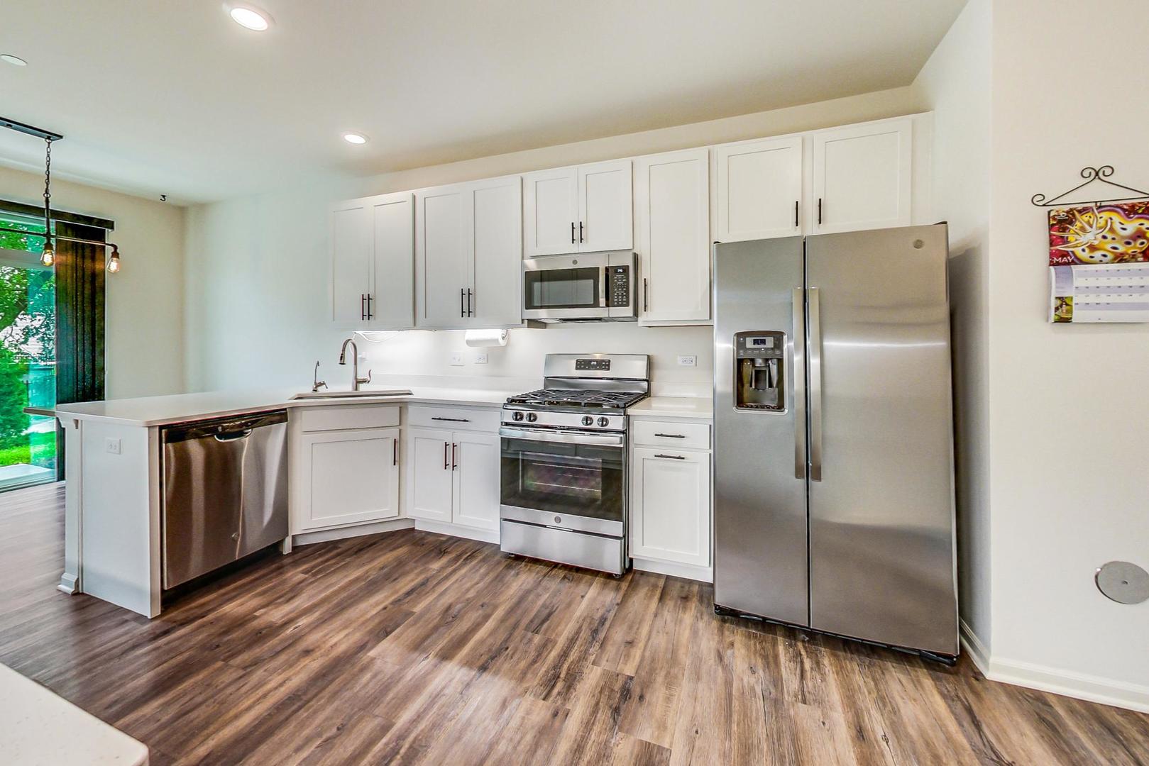 1663 Kraft Avenue Batavia, IL 60510 - Photo 13 of 47 a kitchen with a sink wooden floor and stainless steel appliances
