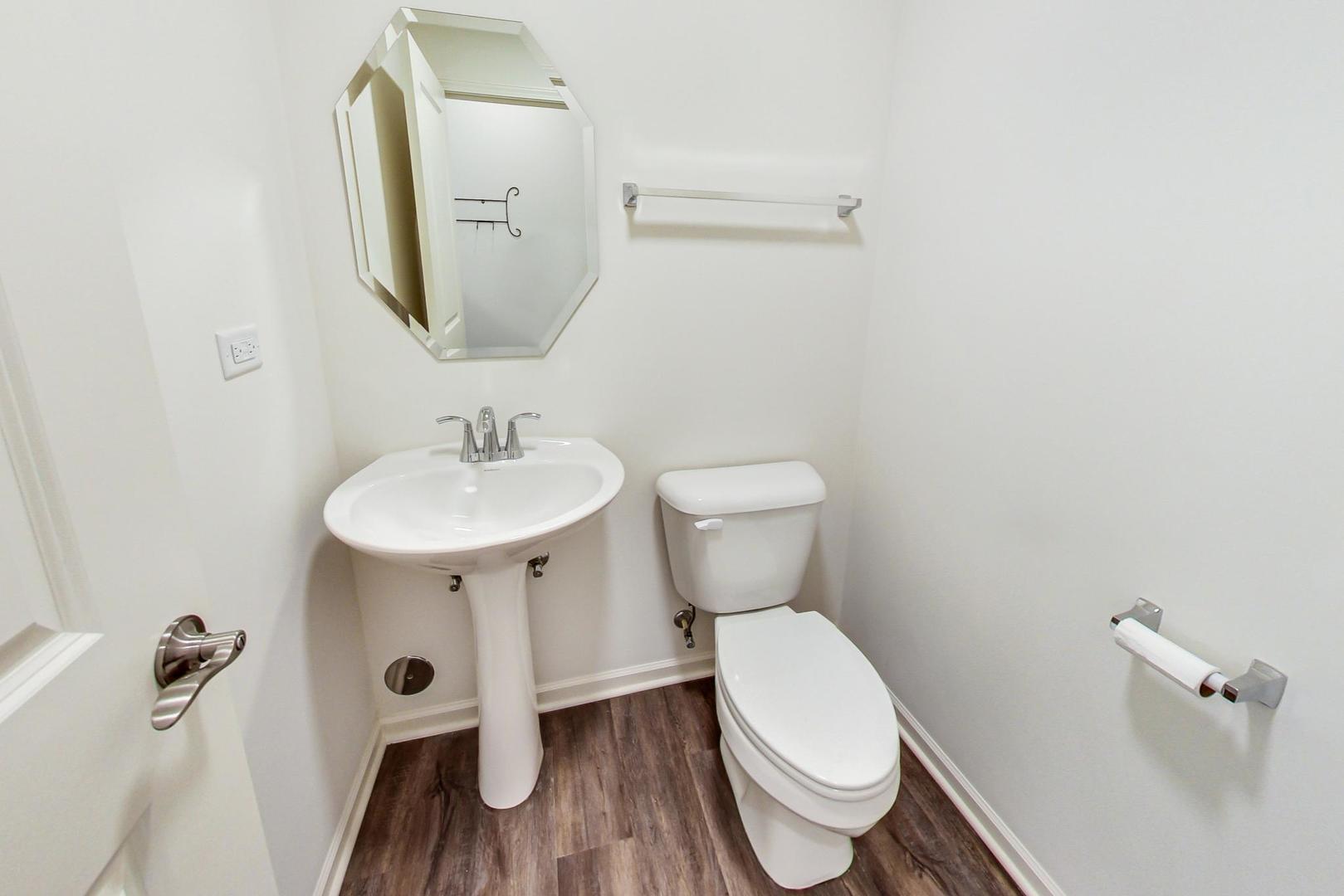 1663 Kraft Avenue Batavia, IL 60510 - Photo 15 of 47 a white toilet sitting next to a bathroom sink