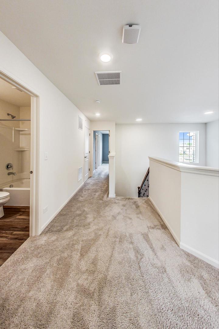 1663 Kraft Avenue Batavia, IL 60510 - Photo 16 of 47 a view of a hallway with wooden floor and a living room
