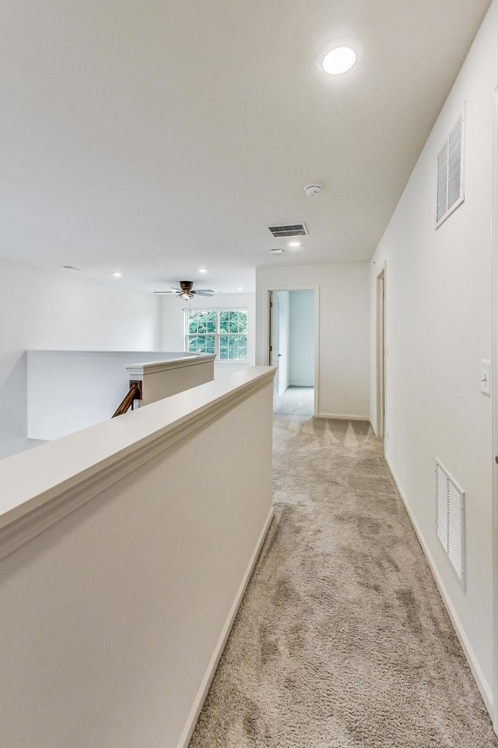 1663 Kraft Avenue Batavia, IL 60510 - Photo 23 of 47 wooden floor in an empty room with a kitchen