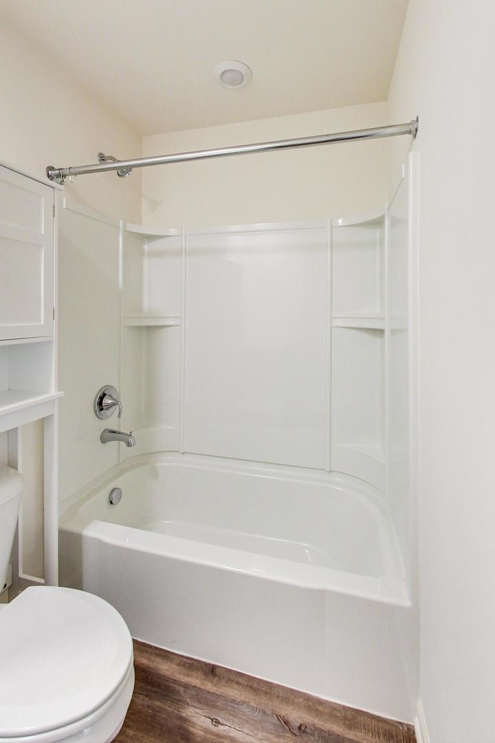 1663 Kraft Avenue Batavia, IL 60510 - Photo 31 of 47 a bathroom with a bathtub and a toilet