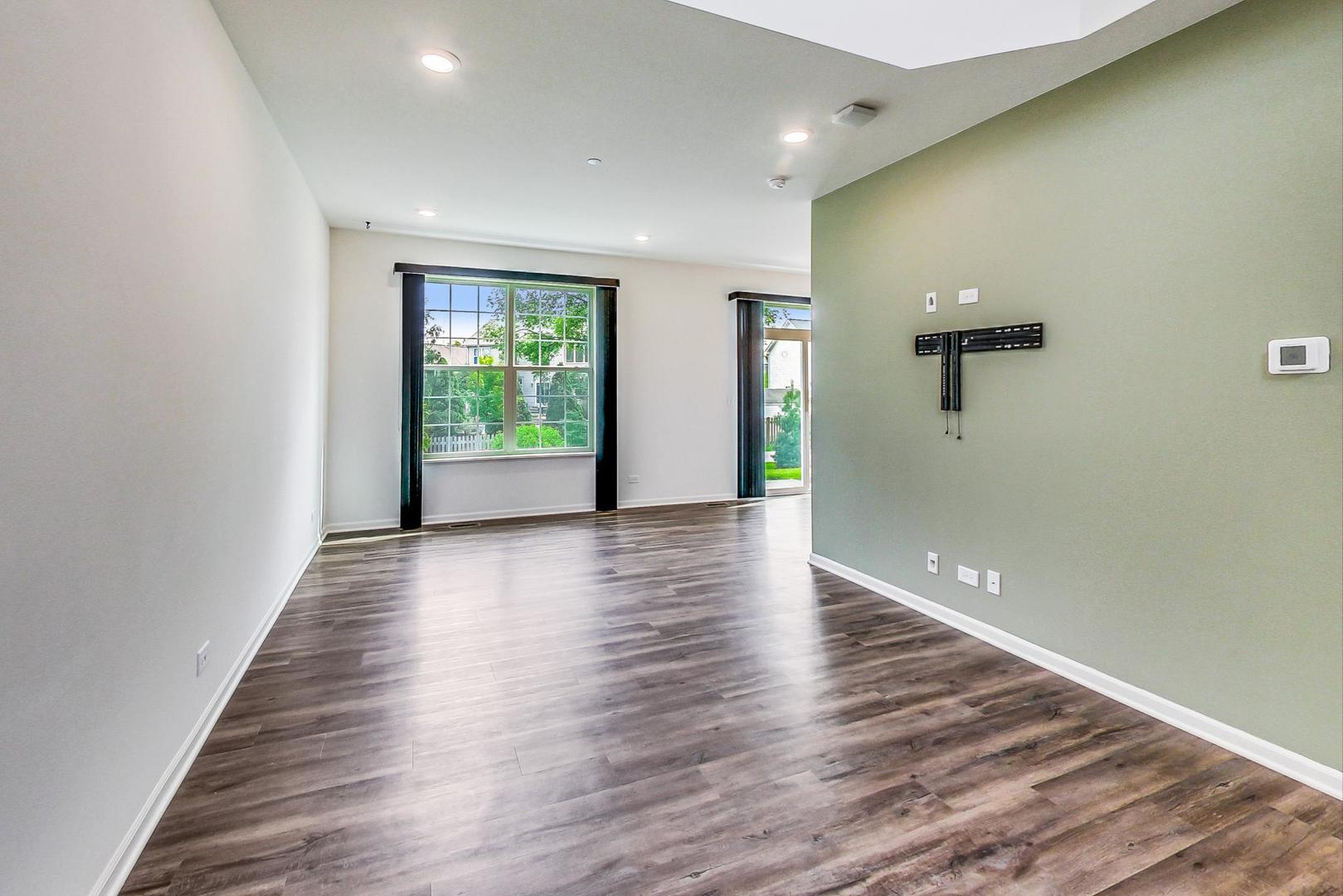 1663 Kraft Avenue Batavia, IL 60510 - Photo 6 of 47 a view of an empty room with wooden floor and a window