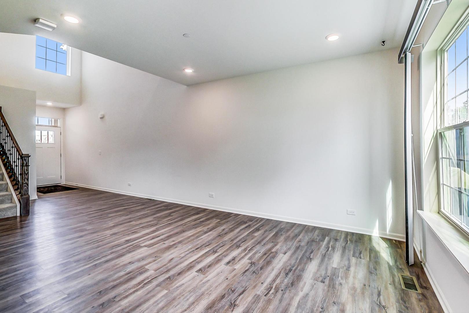 1663 Kraft Avenue Batavia, IL 60510 - Photo 8 of 47 an empty room with wooden floor and windows