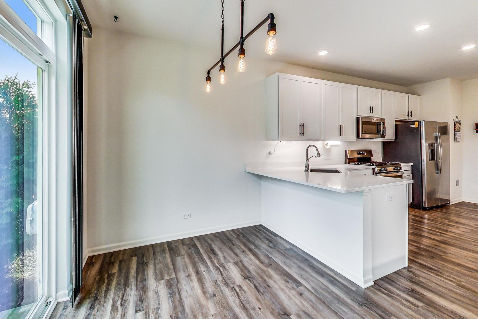 1663 Kraft Avenue Batavia, IL 60510 - Photo 9 of 47 a kitchen with kitchen island a stove a refrigerator and a view of living room