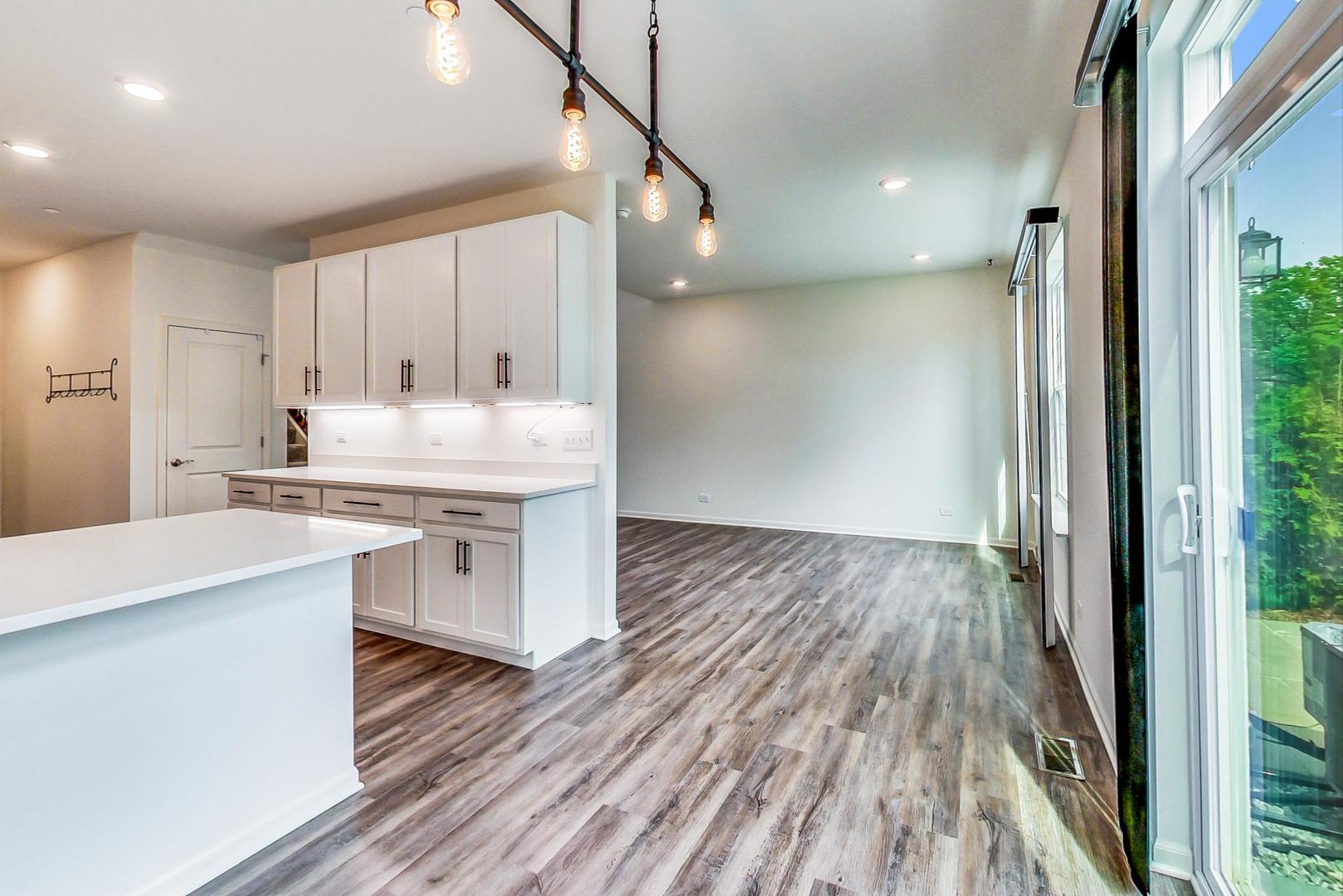 1663 Kraft Avenue Batavia, IL 60510 - Photo 10 of 47 a kitchen with kitchen island a sink stove and wooden floor