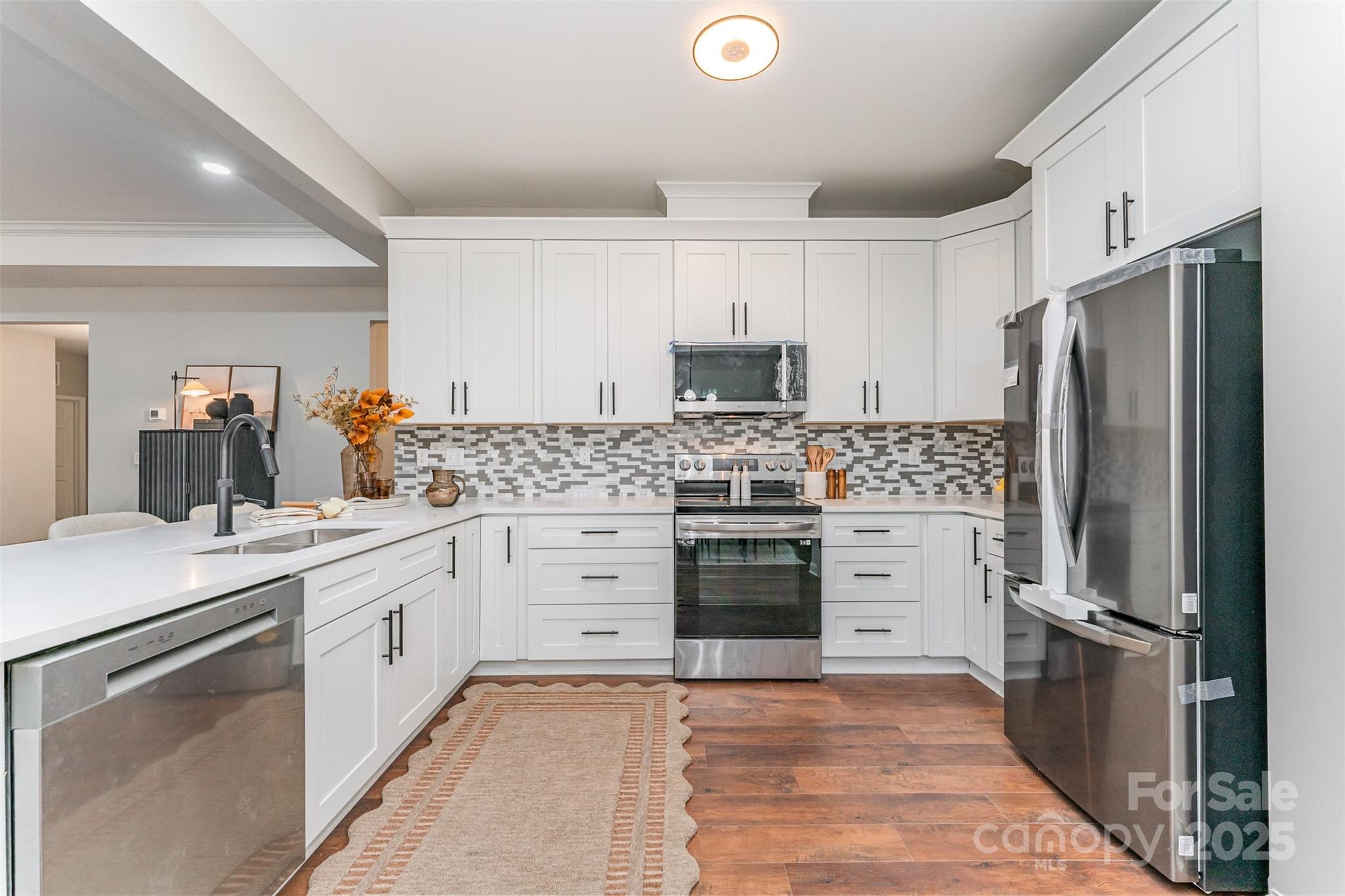 839 Stanley Spencer Mountain Road Gastonia, NC 28056 - Photo 11 of 26 a kitchen with stainless steel appliances a refrigerator stove and sink