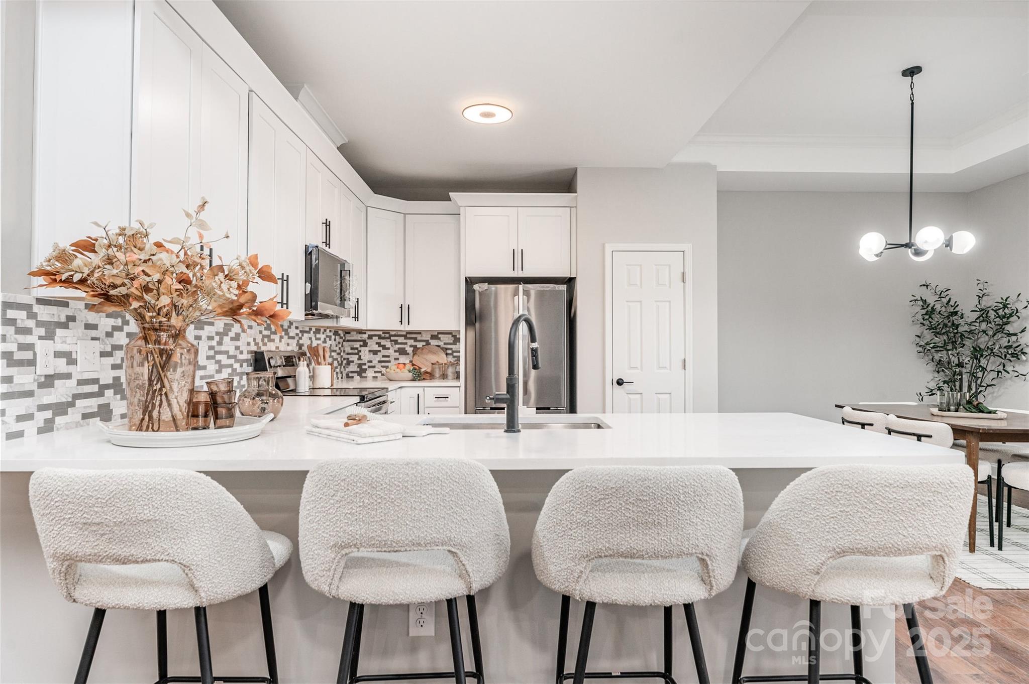 839 Stanley Spencer Mountain Road Gastonia, NC 28056 - Photo 12 of 26 a kitchen with stainless steel appliances kitchen island granite countertop a table chairs and a refrigerator