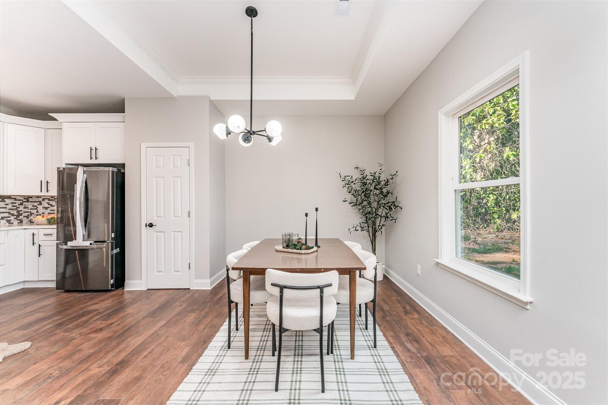 839 Stanley Spencer Mountain Road Gastonia, NC 28056 - Photo 8 of 26 a dining room with furniture a chandelier and wooden floor