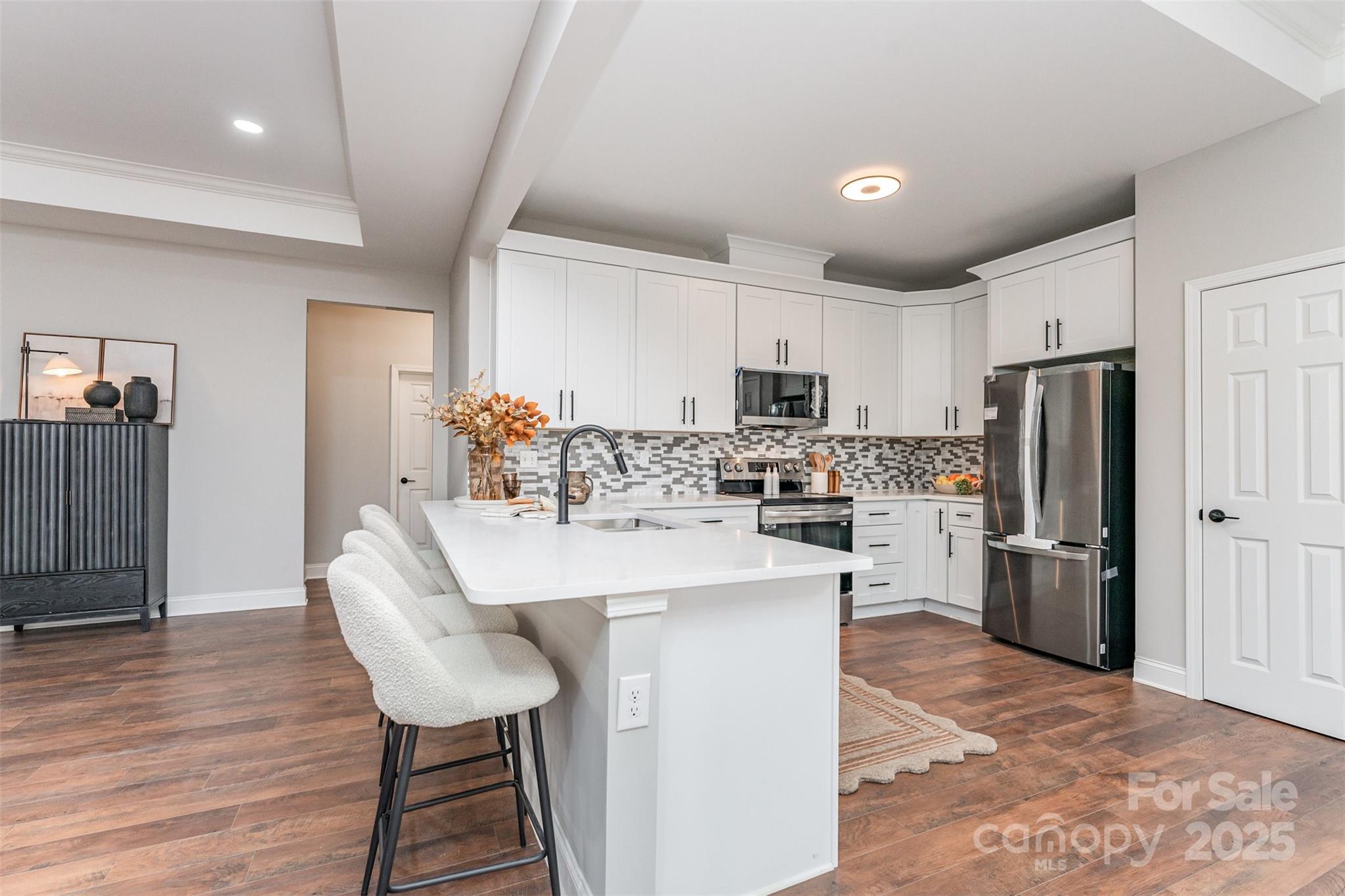 839 Stanley Spencer Mountain Road Gastonia, NC 28056 - Photo 10 of 26 a kitchen with refrigerator a sink and chairs