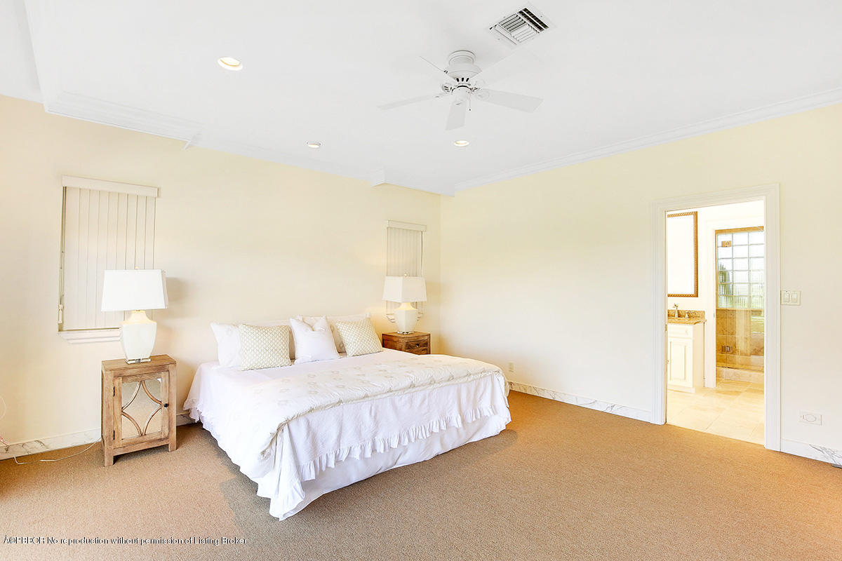 1 Spoonbill Road Manalapan, FL 33462 - Photo 14 of 28 a bedroom with a bed and a night stand