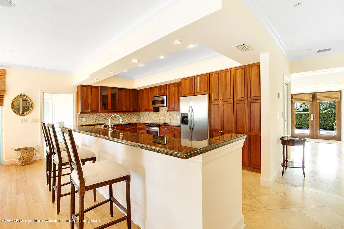 1 Spoonbill Road Manalapan, FL 33462 - Photo 8 of 28 a kitchen with stainless steel appliances kitchen island granite countertop a sink and cabinets