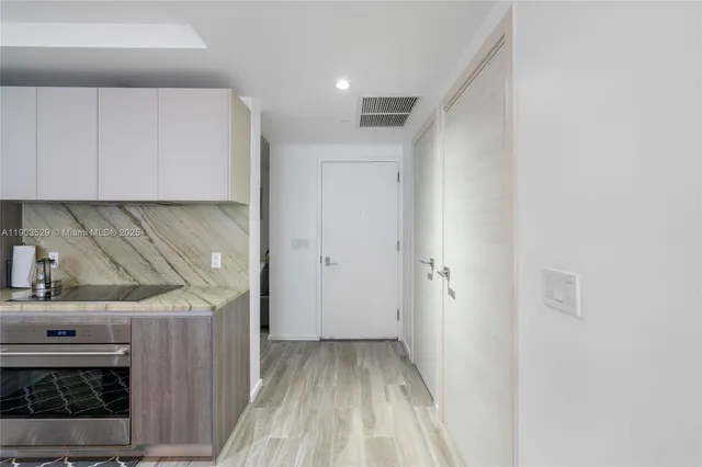 a view of a room with wooden floor