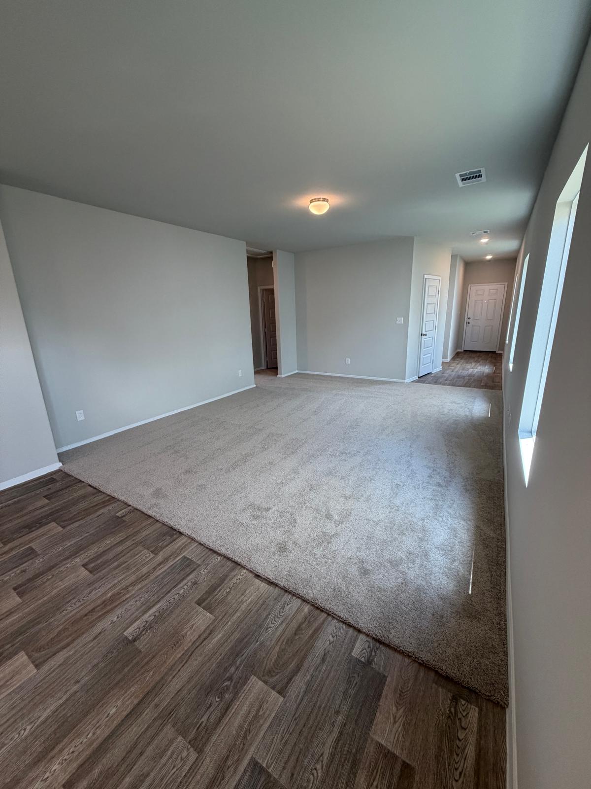 2612 Towy Road Manor, TX 78653 - Photo 28 of 35 Discover a welcoming, neutral-toned living space featuring a combination of soft carpet and resilient wood flooring.