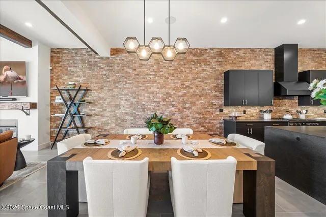 a living room with furniture a rug and a chandelier
