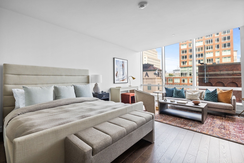 40 Trinity Place, Unit 1603 Boston, MA 02116 - Photo 3 of 11 a bedroom with a bed couch and a large window