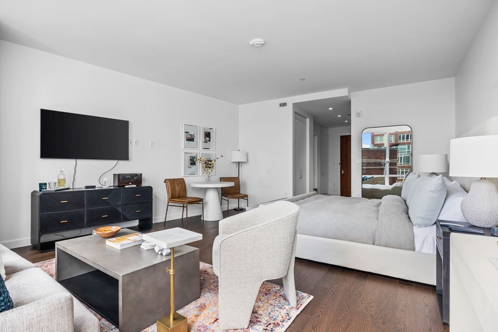 40 Trinity Place, Unit 1603 Boston, MA 02116 - Photo 4 of 11 a living room with furniture and a flat screen tv