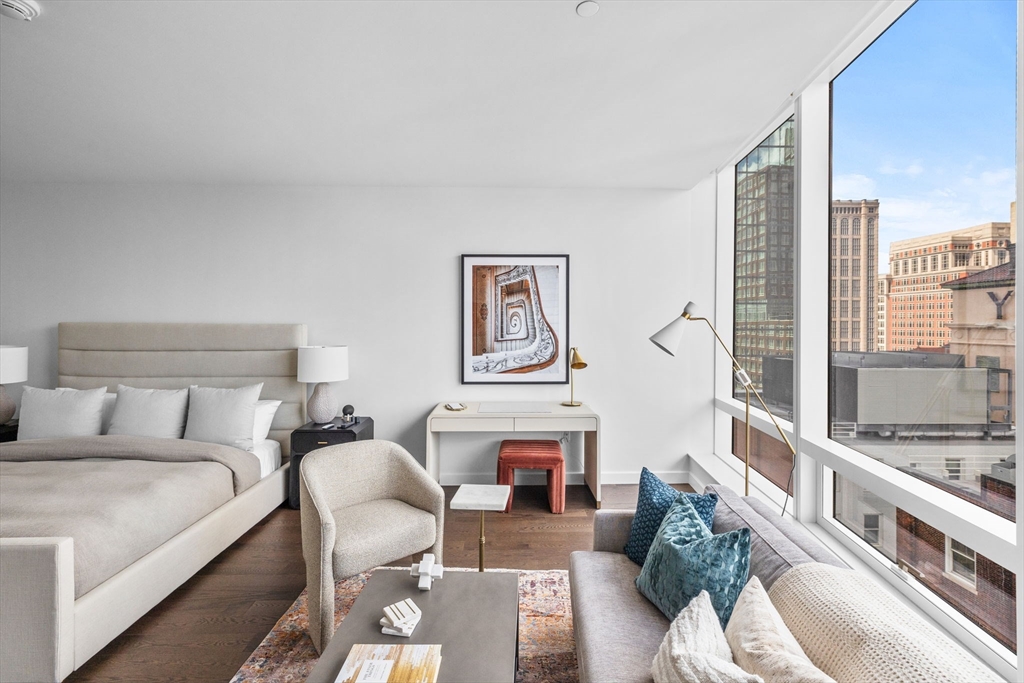 40 Trinity Place, Unit 1603 Boston, MA 02116 - Photo 6 of 11 a living room with furniture and a fireplace