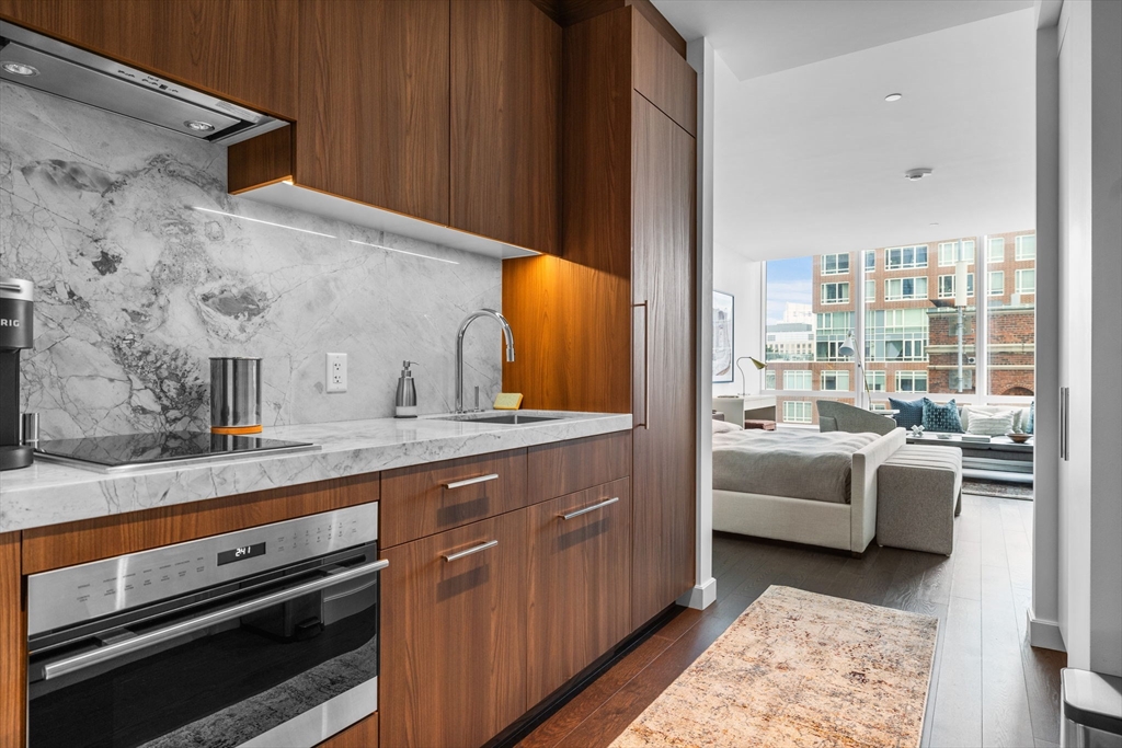 40 Trinity Place, Unit 1603 Boston, MA 02116 - Photo 7 of 11 a living room with furniture and a table