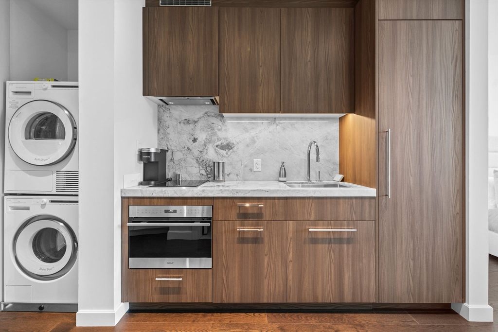 40 Trinity Place, Unit 1603 Boston, MA 02116 - Photo 8 of 11 a view of a storage and utility room with washer and dryer