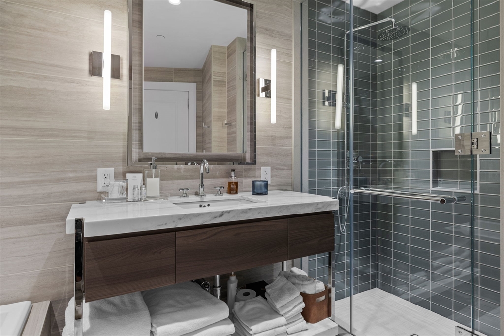 40 Trinity Place, Unit 1603 Boston, MA 02116 - Photo 10 of 11 a bathroom with a sink a toilet and shower