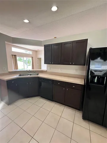 a kitchen with stainless steel appliances a sink and cabinets