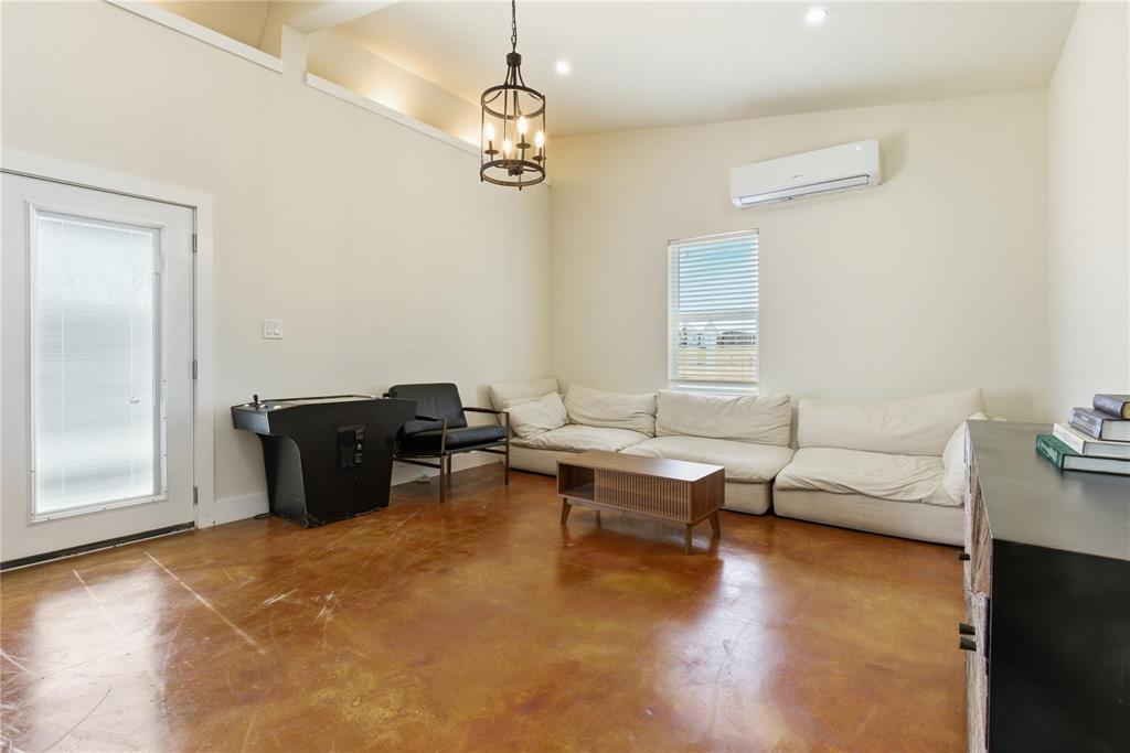 9213 Wilson Road Pilot Point, TX 76258 - Photo 32 of 36 Expansive interior space featuring high ceilings, stained concrete flooring, and an exposed beam