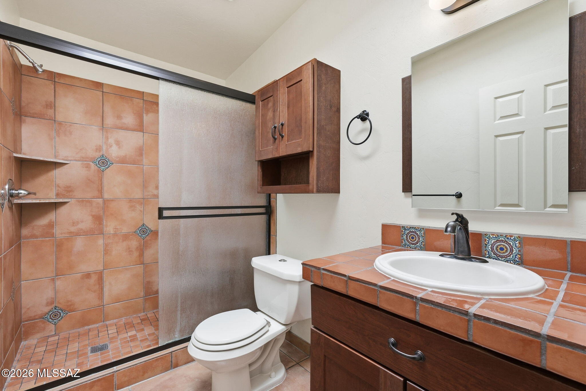 1125 East Kleindale Road Tucson, AZ 85719 - Photo 15 of 49 a bathroom with a granite countertop sink a toilet a mirror and shower