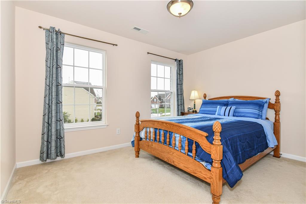 3137 Cranberry Ridge Drive High Point, NC 27265 - Photo 14 of 25 The second bedroom has two windows, overhead lighting, two door closet, and carpet flooring.
